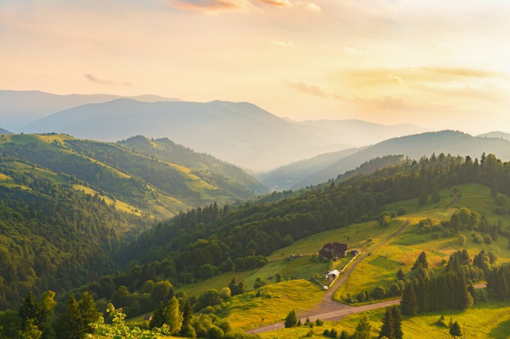 Sunset in green summer mountains. Vibrant photo wallpaper.