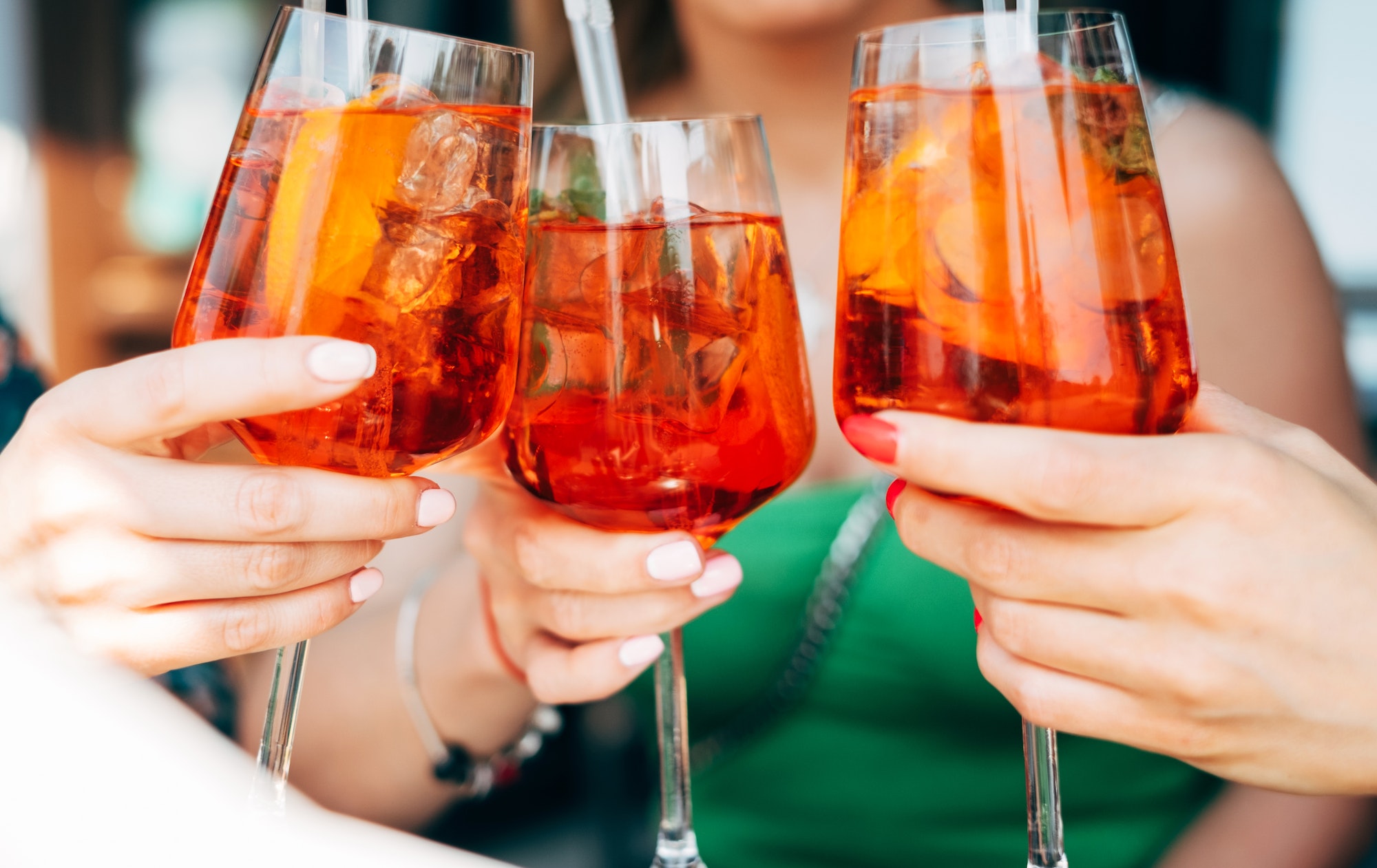 woman toasting with aperol spritz